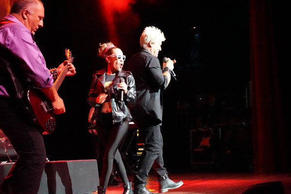 Billy Idol (Michael Tews) and Miley Cyrus (Lourdes White) perform Rebel Yell along side Chris Bolla on guitar.