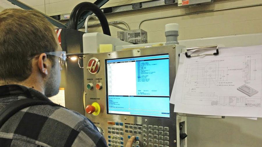 student working with a machine