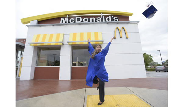 Archway to Opportunities graduate jumping into the air