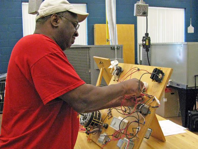 Student working on wiring panel