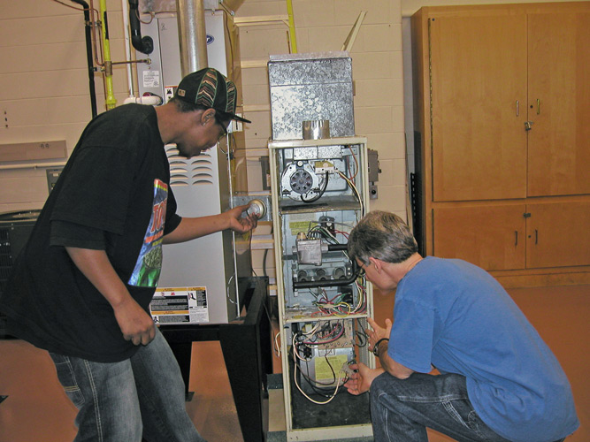 Students in lab doing furnace repair