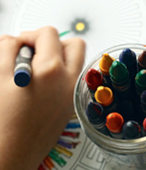 child holding crayon