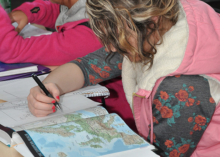 student studing map in class