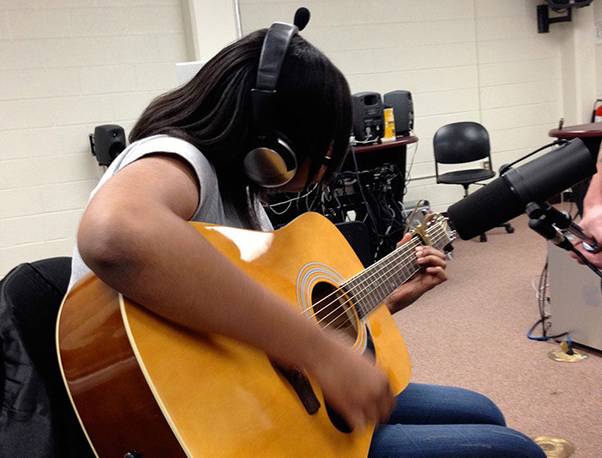 Student playing guitar