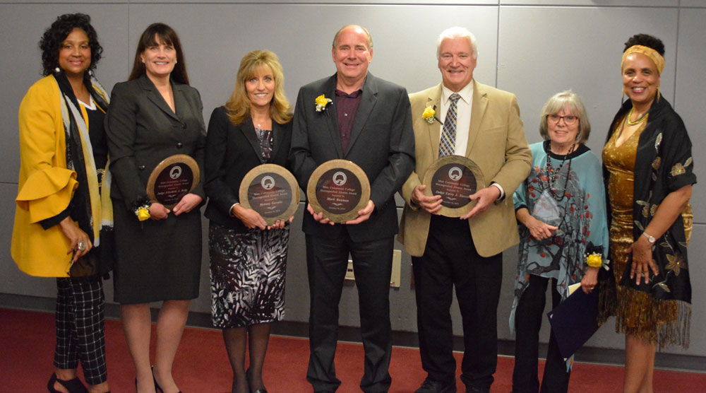 Featured are L-R:  Lennetta Coney, President of The Foundation for Mott Community College, 2019 Distinguished Alumni Award honorees Judge Elizabeth Kelly, Melany Gavulic, Mark Bauman, Judge Larry Stecco, with Sharon Naughton (Outstanding Retiree) and Dr. Beverly Walker-Griffea, President, Mott Community College