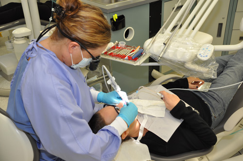 Dental Hygiene Student Cleaning teeth in the dental hygiene lab