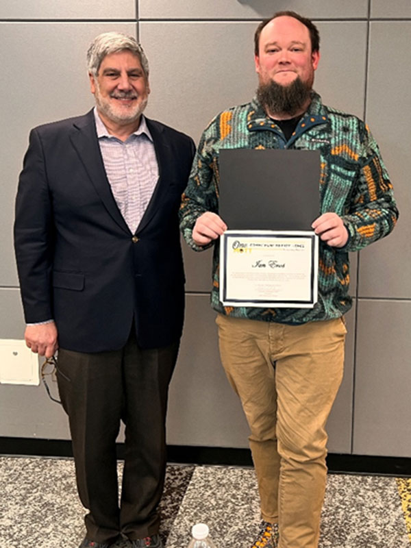 Ian Enos holding award