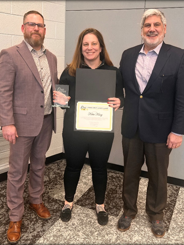 Katie Kiacz holding award