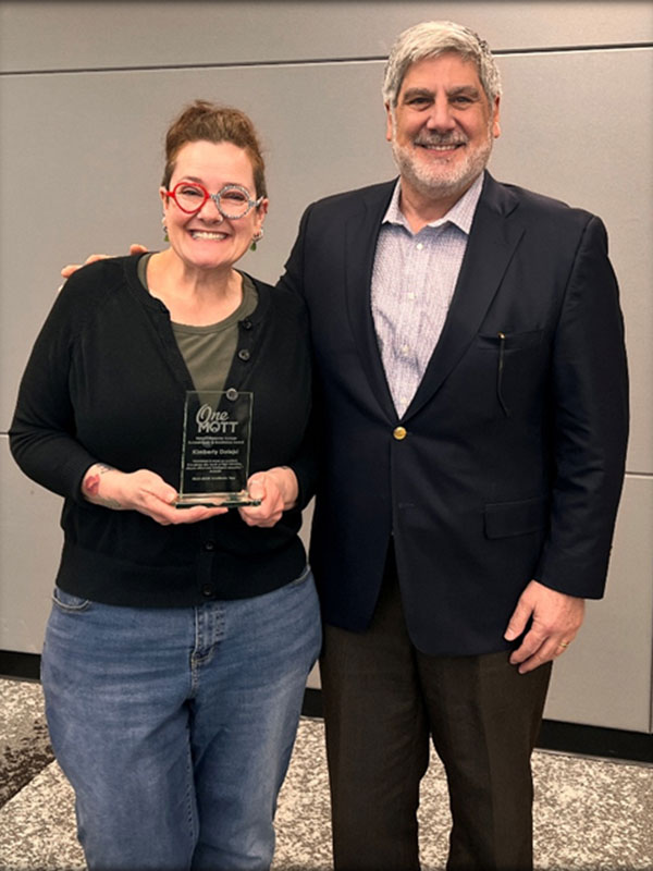Kimberly Dolejsi holding award