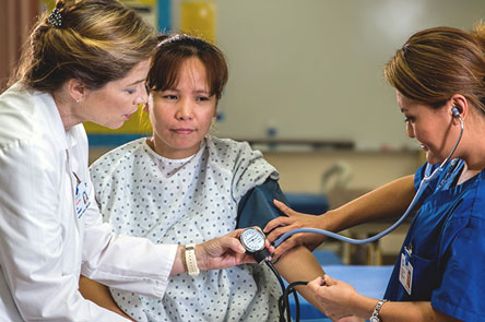 nursing student taking blood pressure