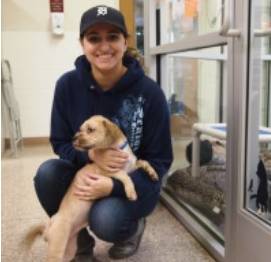 student at humane society with puppy