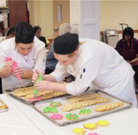 culinary students decorating cookies