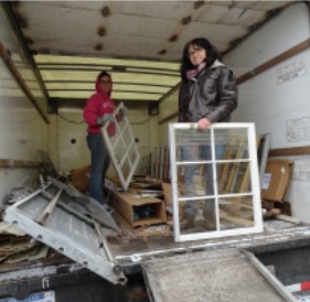 students moving windows as part of service project