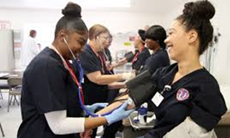 Medical students performing blood pressure check exercise