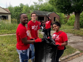 Group of Teens in SYI program doing outdoor clean up activity